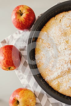 Simple apple pie served with three whole apples