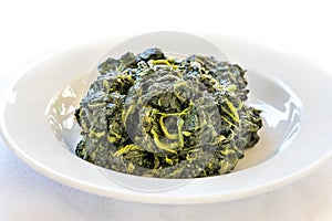 Simple and authentic healthy Italian sauteed spinach served in restaurant in Tuscany
