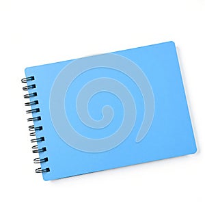A blank, rectangular spiral notebook with a blue cover, isolated on a white background