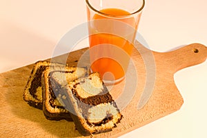 Simple breakfast chocolate roll with carrot juice