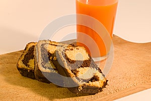 Simple breakfast chocolate roll with carrot juice