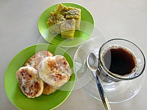 A Simple Breakfast With Traditional Cakes And Blac Coffee