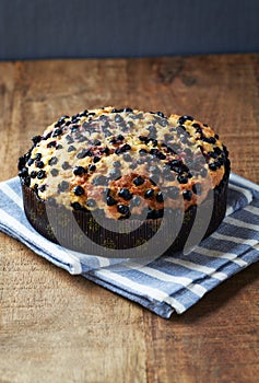 Simple Cake with Bilberries on wooden background.