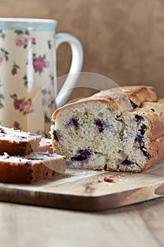 Simple Cake with Bilberries on wooden background.