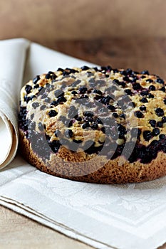 Simple Cake with Bilberries on wooden background.