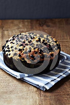 Simple Cake with Bilberries on wooden background.
