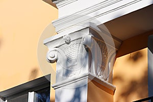 A simple capital on a column on the facade of the building