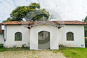 Simple catholic church at the main square in Coqueiros neighborhood Arembepe, Brazil photo