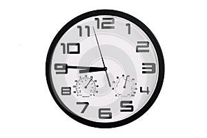 Simple classic black and white round wall clock isolated on white. Clock with arabic numerals on wall shows 20:45 , 8:45