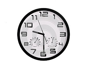 Simple classic black and white round wall clock isolated on white. Clock with arabic numerals on wall shows 9:30 , 21:30