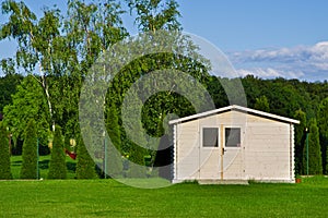 New garden house or shed in green lawn or grass