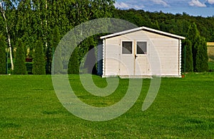 New garden house or shed in green lawn or grass