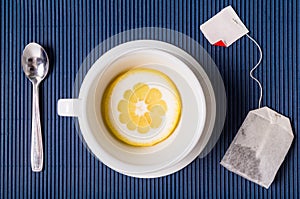 Simple composition with tea cup empty but with slice of lemon, s