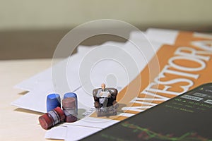 Simple Conceptual Photo, illustration for Senior Investor Mini Figure Toy businessman Seriously watching Running Stock Exchange Si