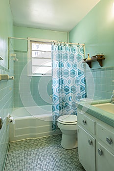 Simple dated 1950s bathroom with green tile.