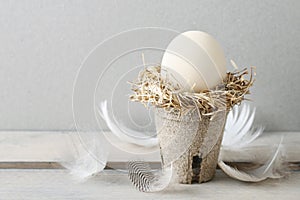 Simple easter decoration with egg and hay wreath
