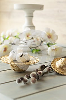Simple easter decoration with egg, hay wreath and white flowers