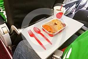 Simple in-flight meal of rice, meat, coffee in disposable utensils