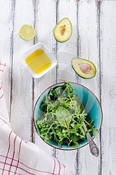 Simple fresh salad ingredients on white wooden backround