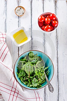 Simple fresh salad ingredients on white wooden backround