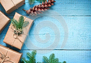 Simple gifts and fir tree christmas ornament decoration on wooden empty blue old background planks