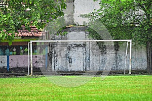 a simple goal on a grass field in a village photo