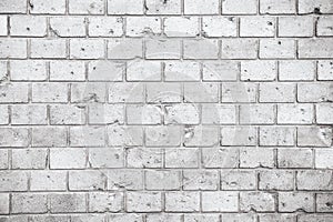 Simple grungy grey white brick wall with light and dark gray shades seamless pattern surface texture background. Wall weathered.