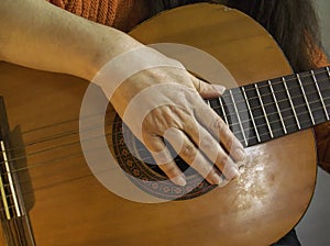 Simple guitar chords, woman playing acoustic guitar, close up photography