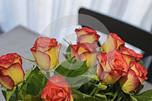 Simple home flowers decoration with fresh bouquet of roses in a vase. Selective focus