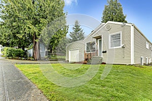 Simple house exterior. View of entrance porch and front yard