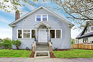 SImple house exterior. View of entrance porch and walkway