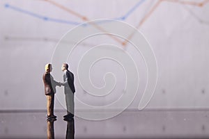 Simple Illustration Photo for Silhouette Two Man Handshaking for Business Agreement with graphic Chart as a background