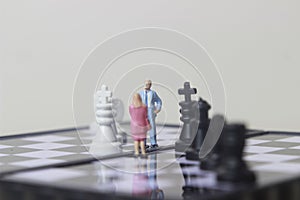 Simple illustration for photo War, Battle or politic situation concept, 2 standing mini figure, man and woman negoitation or