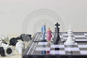 Simple illustration for photo War, Battle or politic situation concept, 2 standing mini figure, man and woman negoitation or