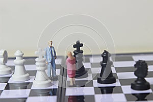 Simple illustration for photo War, Battle or politic situation concept, 2 standing mini figure, man and woman negoitation or