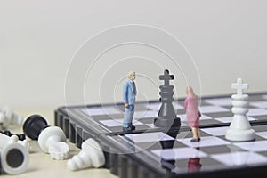 Simple illustration for photo War, Battle or politic situation concept, 2 standing mini figure, man and woman negoitation or