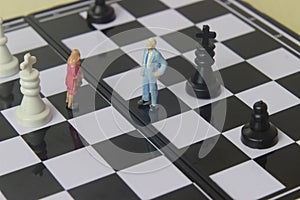 Simple illustration for photo War, Battle or politic situation concept, 2 standing mini figure, man and woman negoitation or