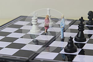 Simple illustration for photo War, Battle or politic situation concept, 2 standing mini figure, man and woman negoitation or