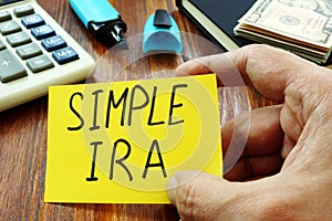 Simple IRA retirement plan in the hand.