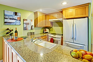 Simple kitchen with wooden cabinets and granite counter top.