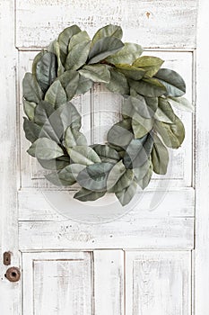 Simple magnolia wreath on antique white door