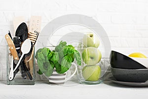 Simple minimalism life is a family kitchen. Cooking items, greens, fruits, apples for a clean, comfortable meal