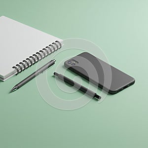 A simple, minimalist arrangement on a light green surface features a closed gray photo
