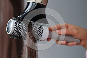 Simple minimalist photo, blow dry hair styling. Close-up of hair dryer, concept cut salon, female stylist.