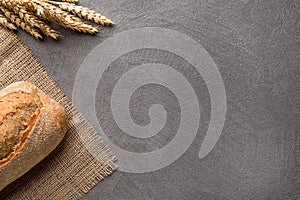 Simple minimalistic bread background, fresh bread and wheat. Top view