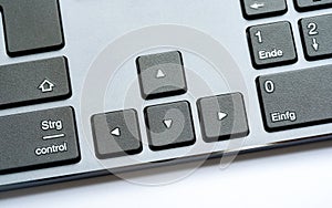Simple modern office desktop PC, computer keyboard arrow keys, object detail, closeup. Arrows, different directions, directional
