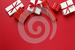 Simple, modern red & white Christmas gifts presents on red background. Festive holiday border. photo