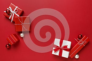 Simple, modern red & white Christmas gifts presents on bright red background. Festive holiday border.