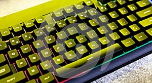 Simple modern rgb backlit gaming mechanical keyboard surface, computer keys closeup, from above, top view, angle. PC keyboard