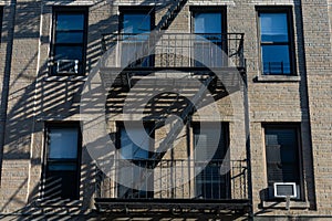 Simple Old Apartment Building Exterior with a Fire Escape in New York City